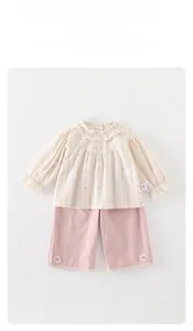 Detail of floral shirt ruffles and pink trousers with white lace flower accents