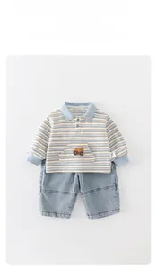 Detail of baby boy striped Polo shirt with car embroidery and matching denim pants