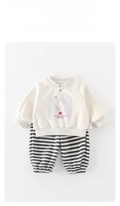 Detail view of baby outfit featuring goose print top and striped pants for spring