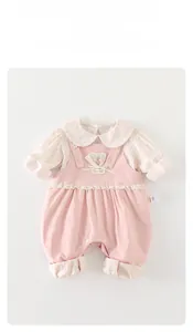 Detailed view of floral long sleeve top and pink overalls with lace and 3D flower deco