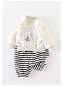 Detail of baby cotton sweatshirt set with wooden button and striped knit pants