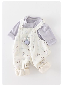 Detail of baby floral overalls set featuring a 3D bunny pendant and soft cotton texture