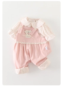Detail of pink toddler overalls with heart lace embroidery and floral undershirt