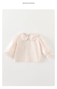 Detail of floral toddler blouse with Peter Pan collar and ruffled elastic cuffs