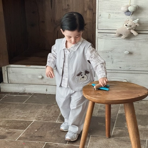 Toddler boys three-piece suit with grey vest, plaid shirt and casual pants in retro setting