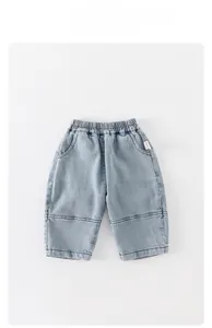 Detail of light blue washed cotton denim trousers for boys with elastic waistband