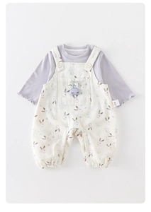 Detail view of baby floral overalls set with cute rabbit doll and wavy sleeve cuffs