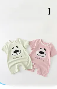 Detail of short-sleeved cotton baby rompers with cute dog prints and snap buttons