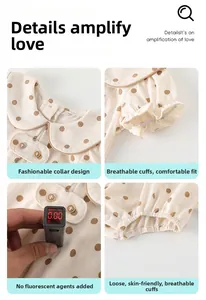 Detail view of polka dot baby romper showing zero fluorescence test and Peter Pan collar