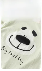 Close-up of cute cartoon dog pattern and soft cotton fabric on baby short sleeve romper