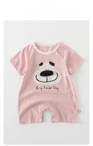 Detailed view of baby pink cotton romper with snap buttons and cute dog print
