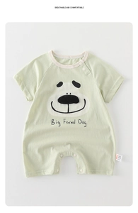 Detail of baby short sleeve romper showing green fabric with cute big face dog print