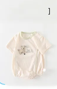 Detail of baby summer bodysuit featuring cute dog print and premium snap buttons