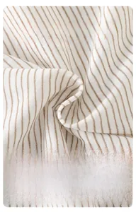 Detailed macro view of soft breathable light brown striped cotton fabric for baby clothes