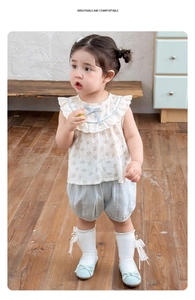 Detail of girls floral short sleeve blouse and light blue bloomers summer set