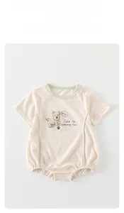 Detail of baby short sleeve bodysuit with snap button closure and cute puppy print