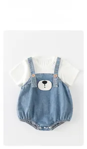 Detail view of the cotton T-shirt and denim baby bodysuit with a cute cartoon bear patch