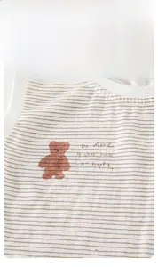 Close-up of baby tank top featuring brown bear print and soft cotton striped fabric texture