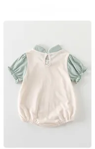 Detail of baby cotton romper with mandarin collar and puff sleeves in Chinese style