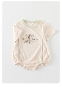 Close-up of baby short sleeve bodysuit with puppy print and green contrast binding