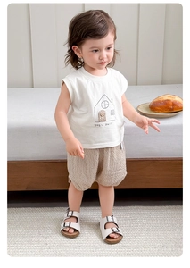 Detail view of cotton baby tank top with house print and checkered summer shorts set