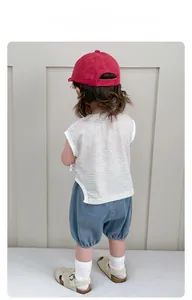 Rear view of a boy wearing a striped cotton vest and blue denim shorts for summer