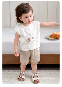 Detail of baby boys cotton sleeveless T-shirt with house print and checkered shorts