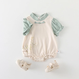Chinese style baby romper with magnolia pattern and matching mesh sandals on white background