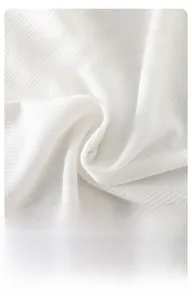 Close-up of white ribbed knit fabric showing soft texture and breathable material
