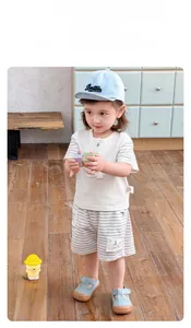 Detail shot of a boy's Korean style casual summer outfit set with striped shorts and hat