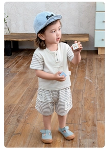 Detail of toddler summer outfit with cream striped T-shirt and grey elastic cotton shorts