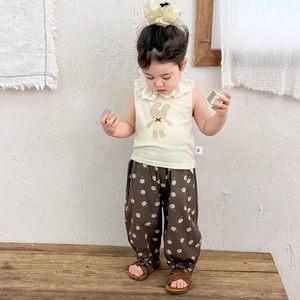 Toddler summer set with bunny sleeveless top and brown floral trousers on Asian model