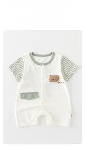 Detailed view of baby romper with 3D bear embroidery and green checkered sleeves