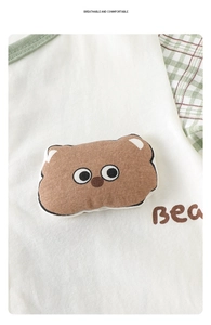 Detail of baby cotton onesie with 3D bear embroidery and green plaid trim