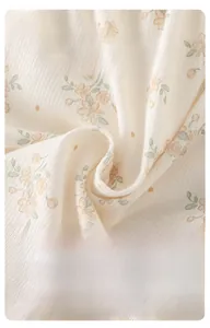 Détail du tissu en coton côtelé doux avec imprimé floral orange pour body de bébé
