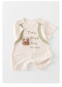 Detail of baby romper with 3D bear patch, contrasting shoulders, and snap buttons