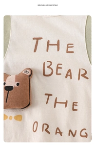 Close-up of baby romper featuring a soft 3D bear plush and brown letter printing