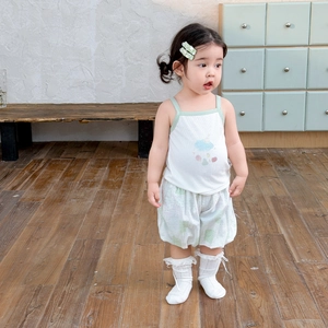 Girls summer two-piece outfit featuring white cloud camisole and green printed shorts