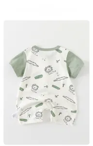 Detail view of cotton baby bodysuit featuring cute lion prints and wild free slogan
