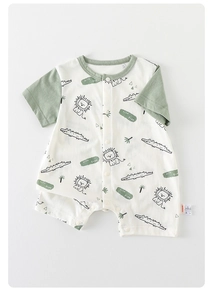 Detail of short-sleeve baby romper featuring lion and crocodile prints with wild free text