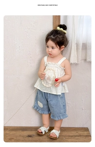 Detail of floral strap top and denim shorts with lace ruffles for toddler girls
