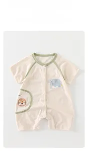 Detailed view of baby cotton romper with lion pocket and elephant print features