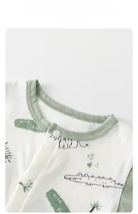 Detail of baby cotton romper featuring green rib collar and cute wild animal print