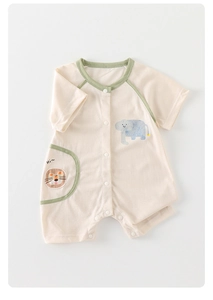 Detail of baby cotton romper featuring cartoon elephant print and snap button closure