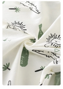 Detail of soft breathable cotton baby fabric with cartoon lion and crocodile prints