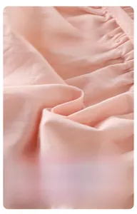 Detail of pink cotton knit fabric showing soft texture and breathable material for babies
