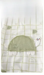 Macro detail of breathable cotton baby romper featuring a cute 3D turtle embroidery patch