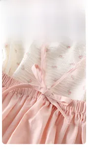Detail of pink floral waffle fabric with elastic waist and bow for baby girl dress