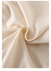 Detailed close-up of soft organic cotton fabric in beige for newborn baby bodysuit