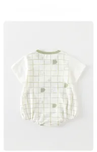 Close-up of baby bodysuit with green checkered pattern, cotton texture and mushroom print